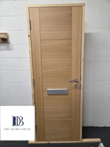 Pre-hung, modern timber fire door with horizontal grain and side stiles, shown with stainless steel hardware.