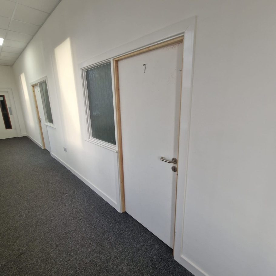Internal White Fire Doors Supply & Fit Set of white internal timber fire doors installed in a commercial corridor, ensuring fully certified fire compartmentalisation