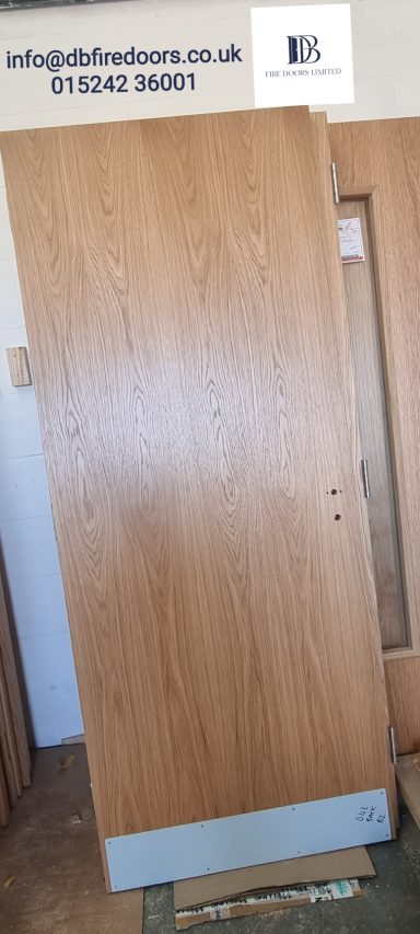Flush oak veneer fire door with kick plate